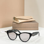 Black cat-eye glasses with clear lenses and gold-tone logo hinge