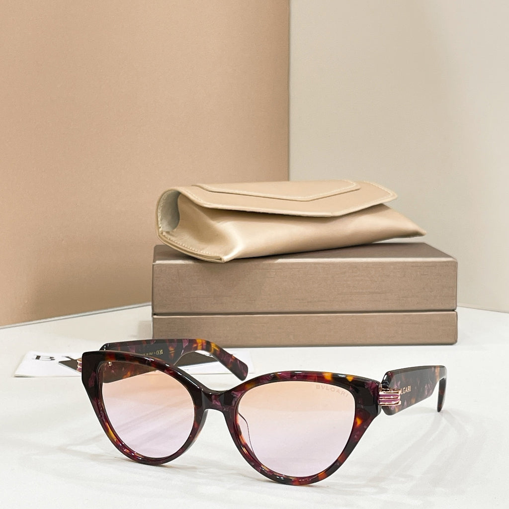 Tortoise-brown cat-eye glasses with clear lenses and gold-tone logo hinge