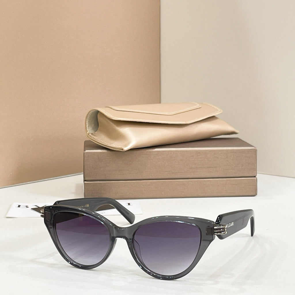 Black cat-eye glasses with dark lenses, glossy frame and gold-tone logo detail