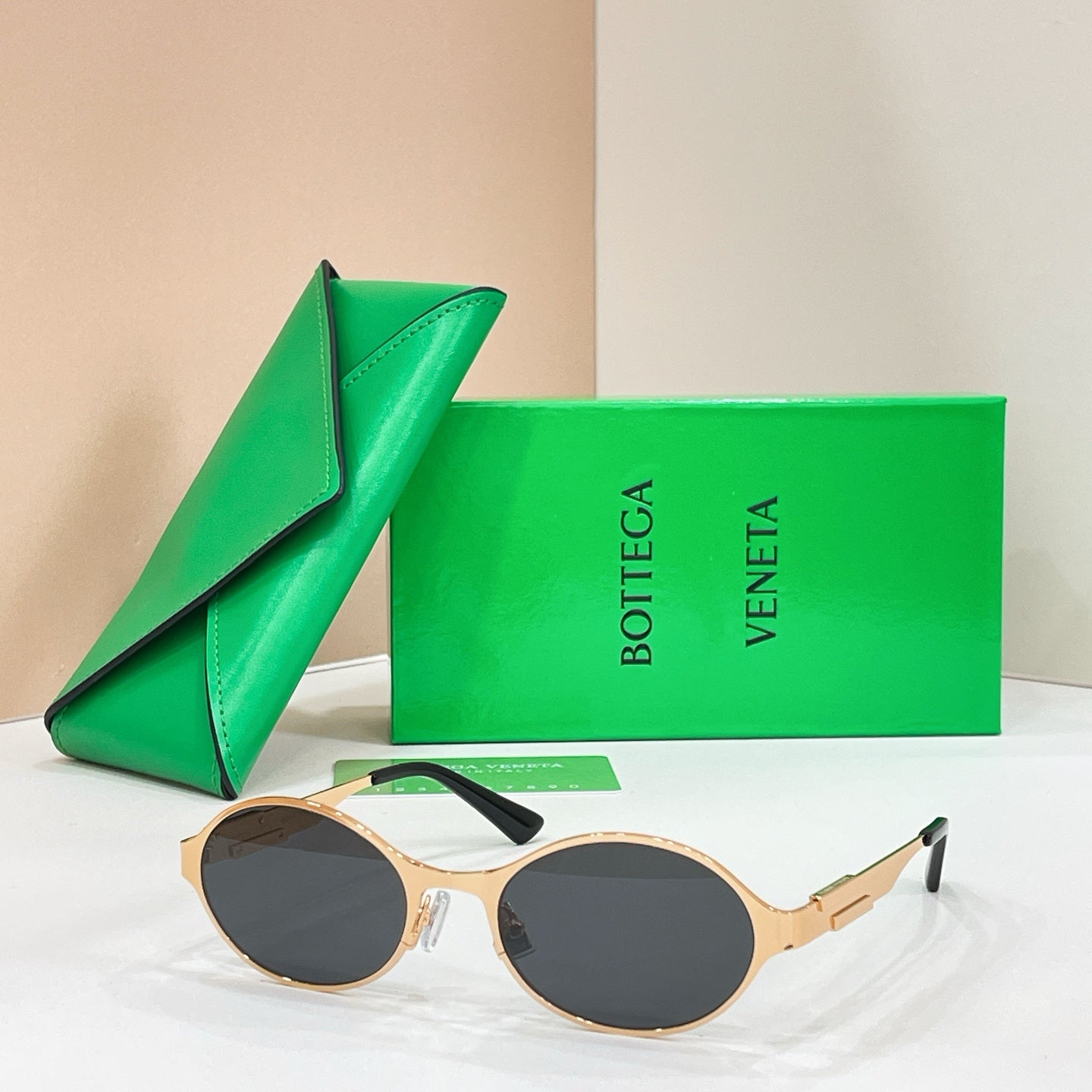 Bottega Veneta round sunglasses with gold-tone frame and dark lenses