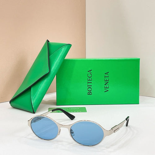 Bottega Veneta round sunglasses with gold-tone frame and blue lenses