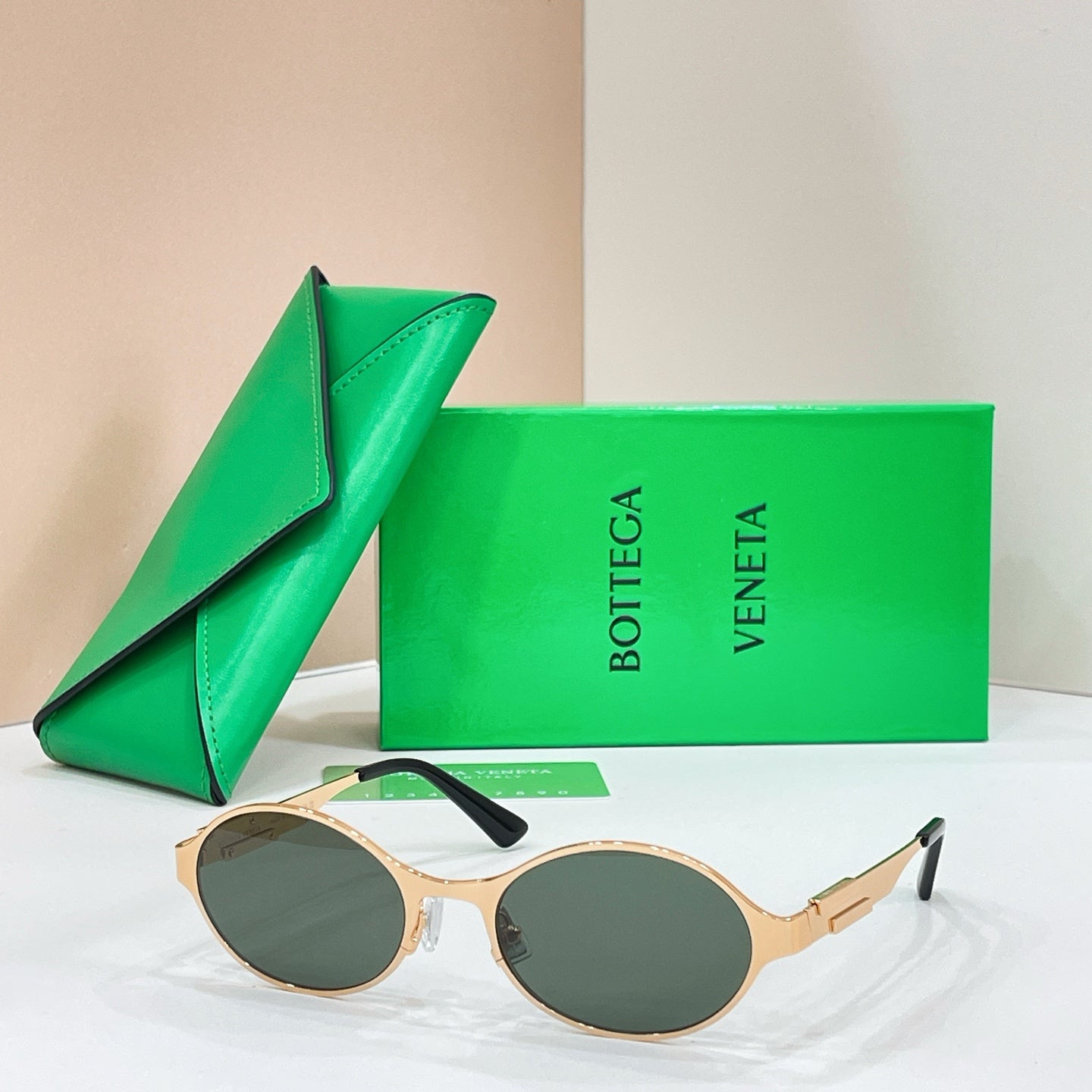 Bottega Veneta round sunglasses with gold-tone frame and green-tinted lenses