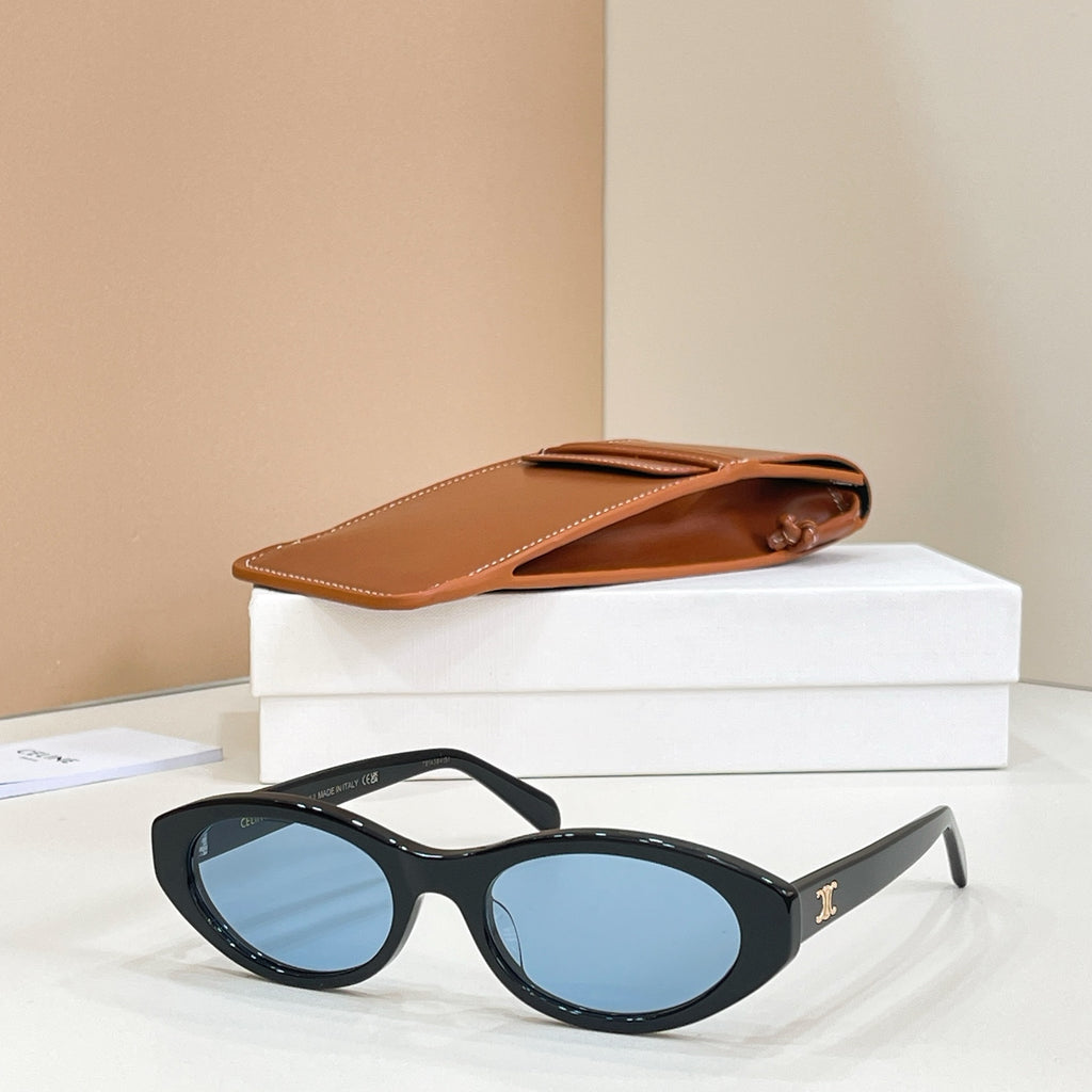 Celine sunglasses with black frames and blue tinted lenses, side view.