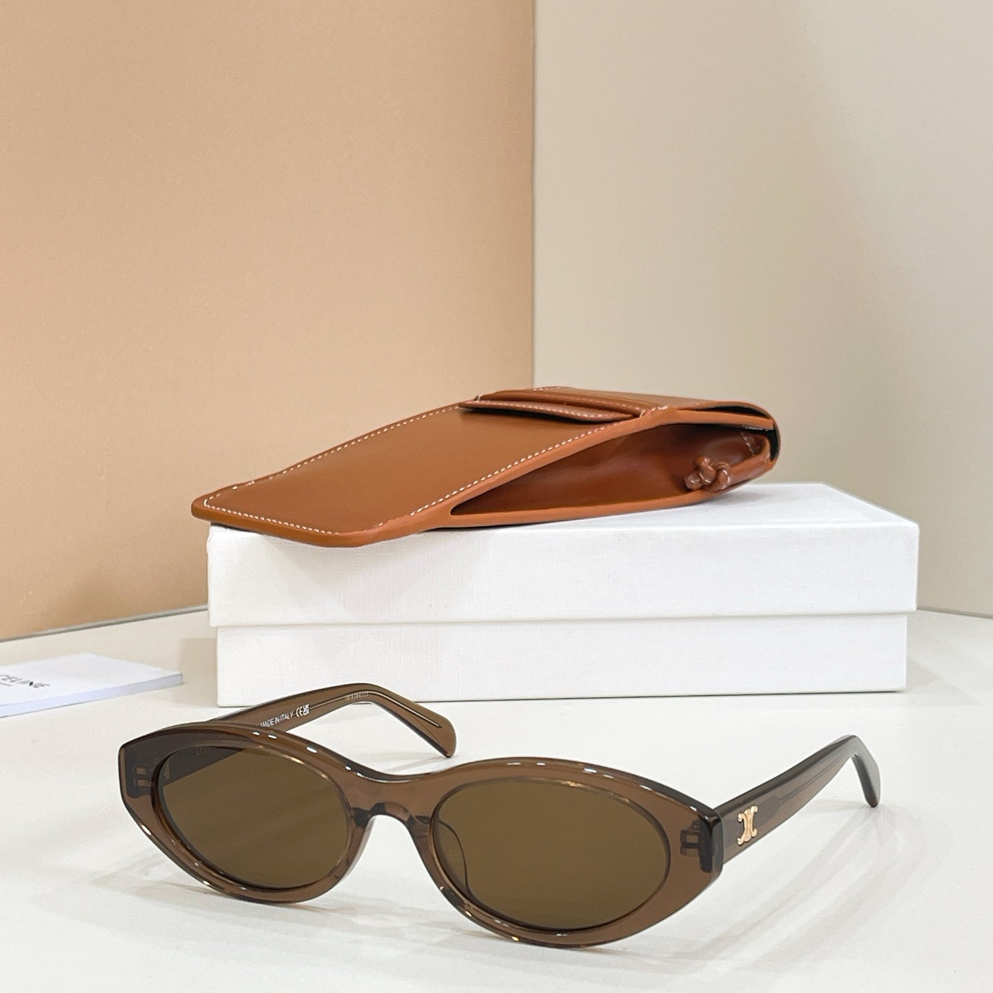 Celine sunglasses with brown frames and dark lenses, front angled view.