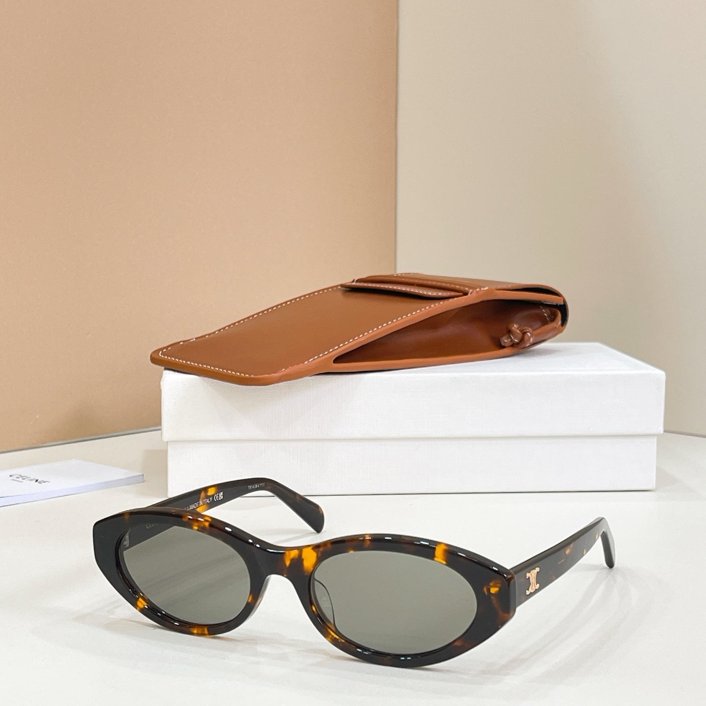 Celine sunglasses with tortoiseshell frames and dark lenses, side view.