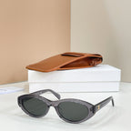 Celine sunglasses with dark gray frames and green tinted lenses, side view.