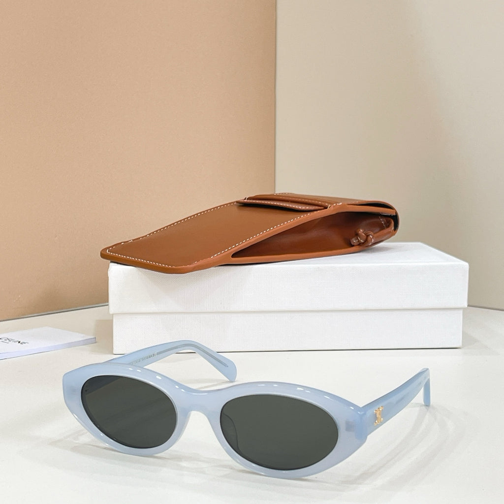 Celine sunglasses with light blue frames and dark lenses, side view.