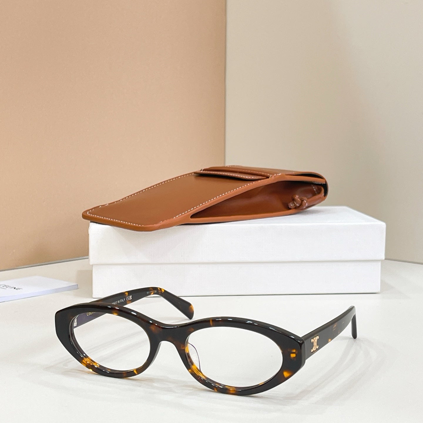 Tortoise-style rounded full-rim eyeglasses with a glossy finish