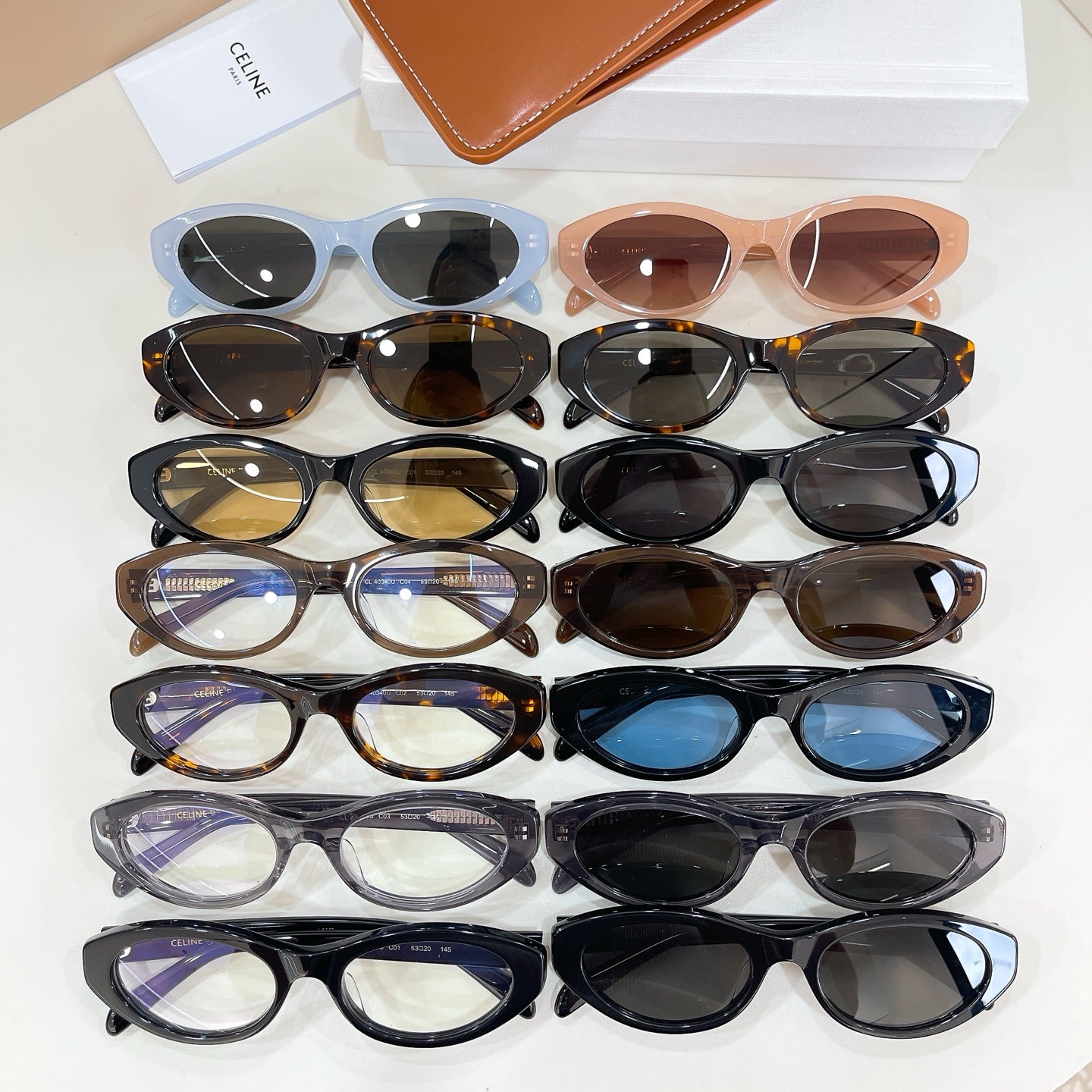 Assorted eyeglasses in multiple colors with oval lenses on display