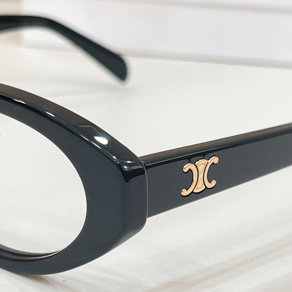 Black eyeglass temple with gold-tone Celine logo detail
