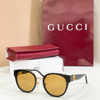 Gucci sunglasses with black frames and mirrored yellow lenses, gold-tone logo detail