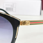 Gucci glasses close-up: gold temple with multicolor stripe and black frame