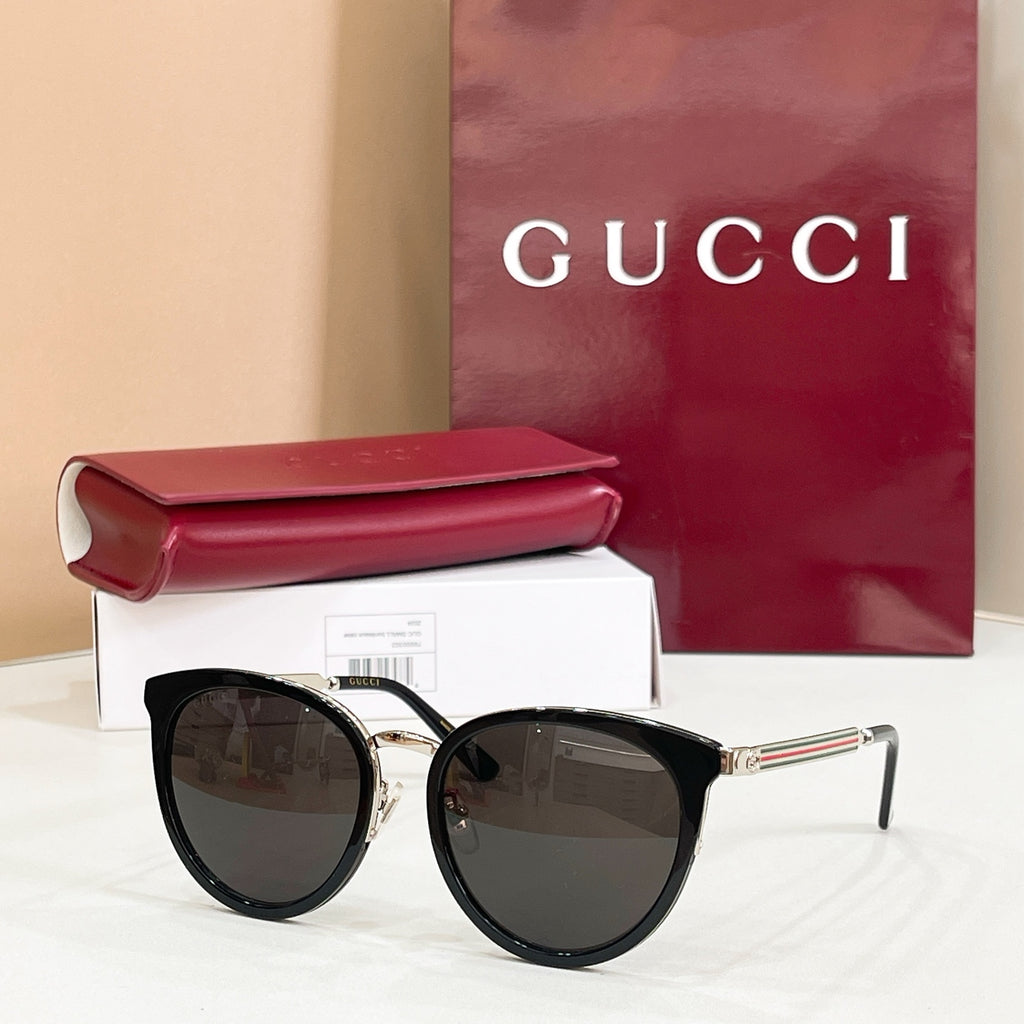 Gucci glasses with black cat-eye frames and dark tinted lenses