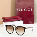 Gucci glasses with black cat-eye frames and light brown tinted lenses