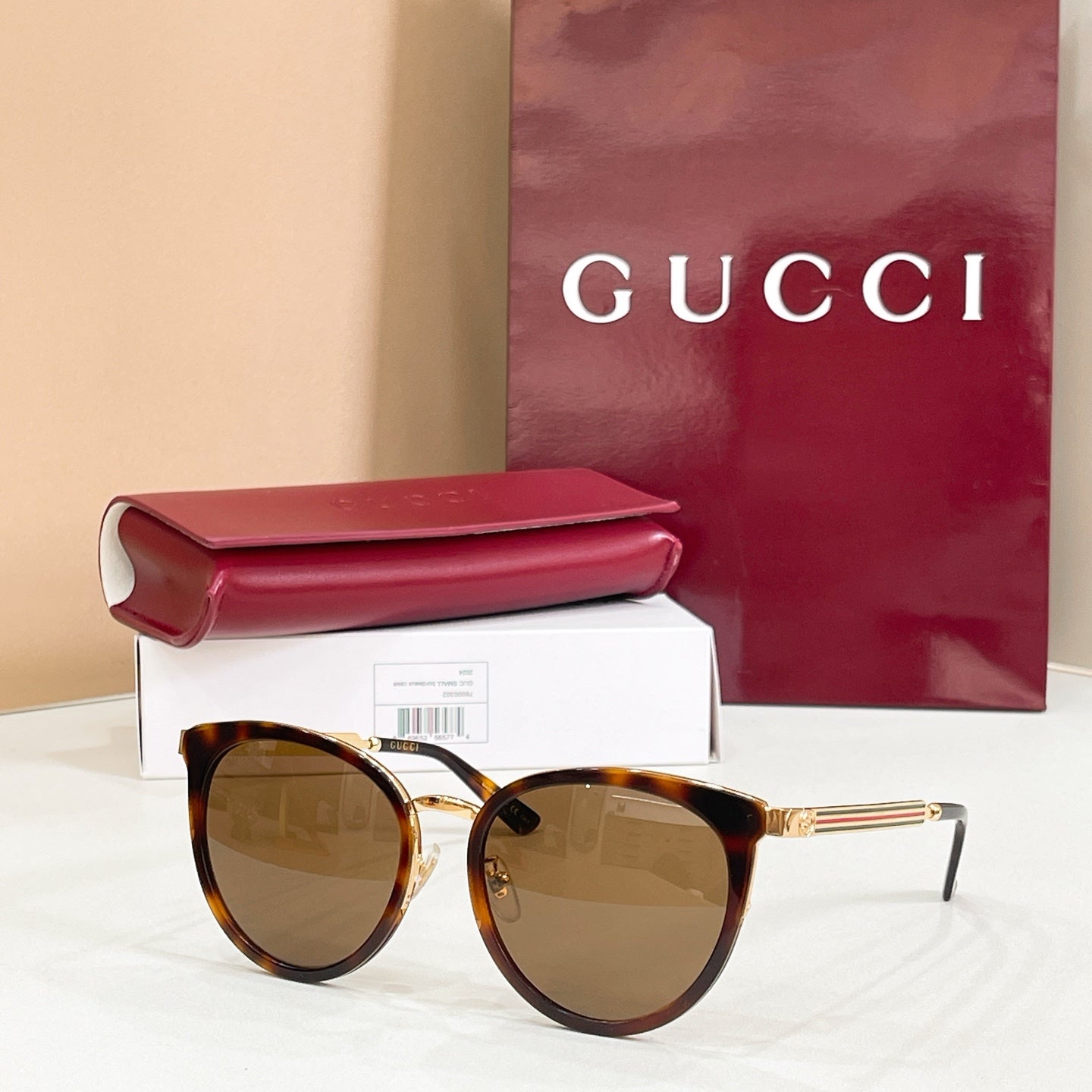 Gucci glasses with tortoiseshell frames and tan tinted round lenses