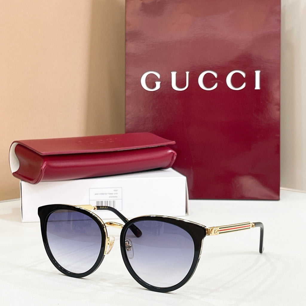 Gucci glasses with black cat-eye frames and pale blue tinted lenses