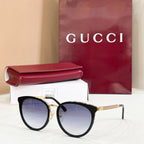 Gucci glasses with black cat-eye frames and pale blue tinted lenses