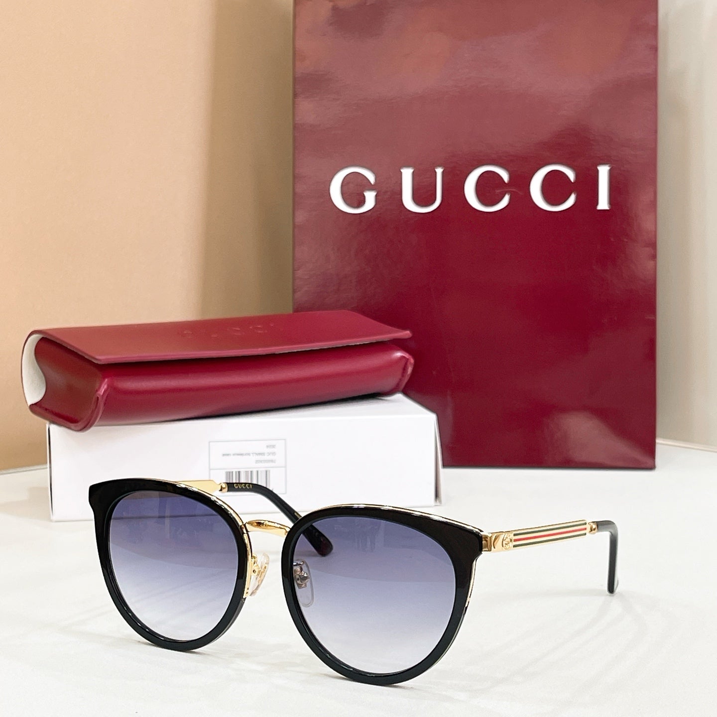 Gucci glasses with black cat-eye frames and pale blue tinted lenses
