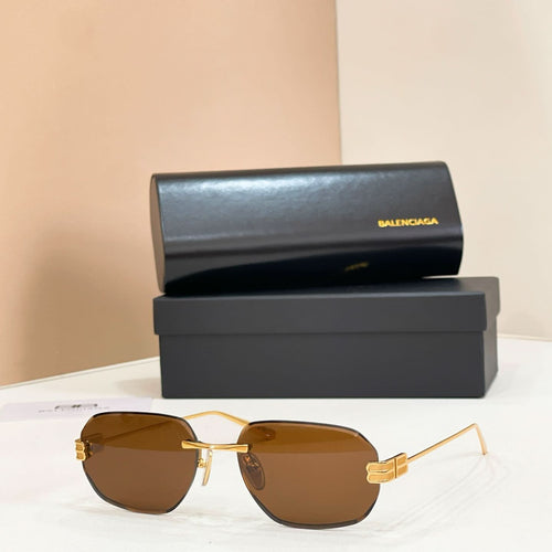 Balenciaga sunglasses with brown tinted lenses and gold metal frame