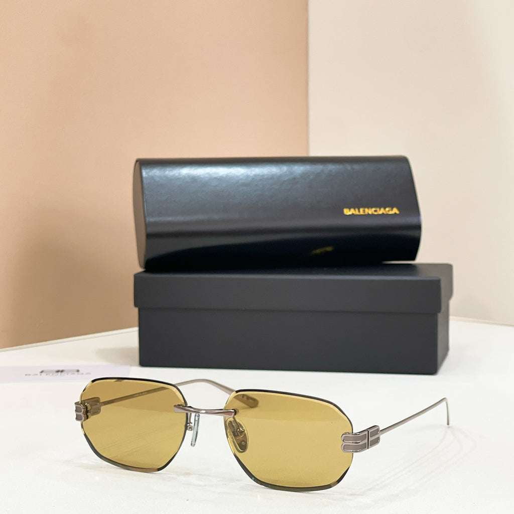 Balenciaga sunglasses with yellow tinted lenses and gold metal frame