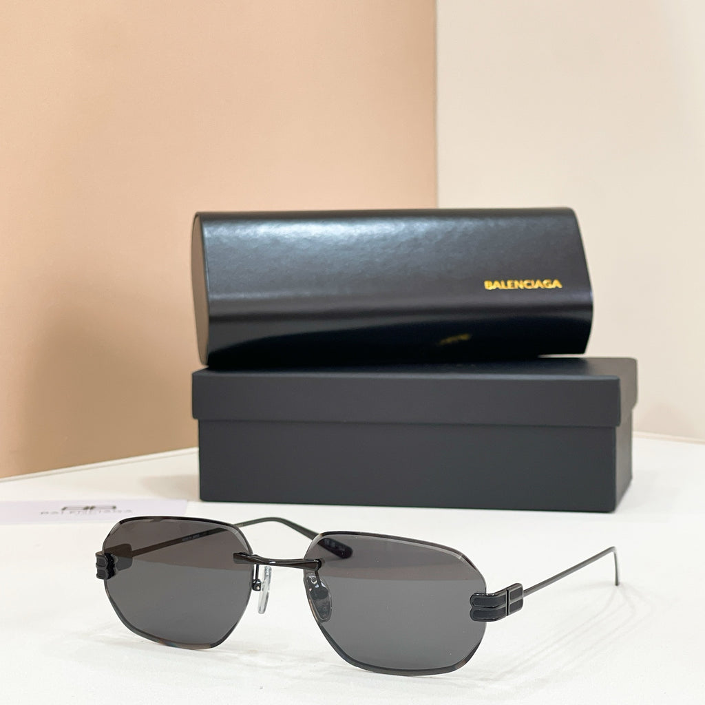 Balenciaga sunglasses with charcoal tinted lenses and gold metal frame