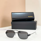 Balenciaga sunglasses with charcoal tinted lenses and gold metal frame