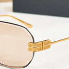 Balenciaga sunglasses close-up: gold metal temple detail with tinted lens