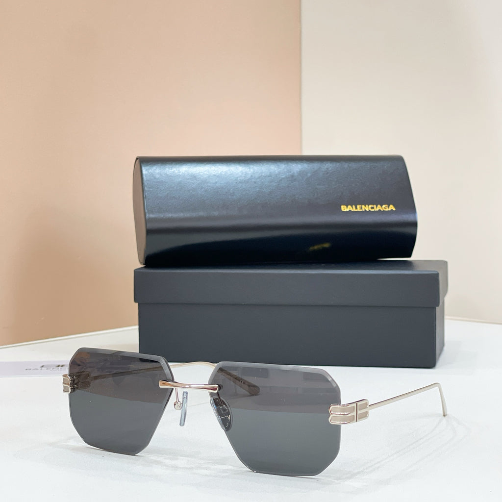 Sunglasses with dark gray lenses and gold metal frame, front view