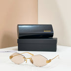 Sunglasses with gold-tone metal frame and clear-to-brown gradient lenses