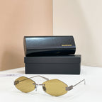 Sunglasses with gold-tone metal frame and light yellow-tinted lenses