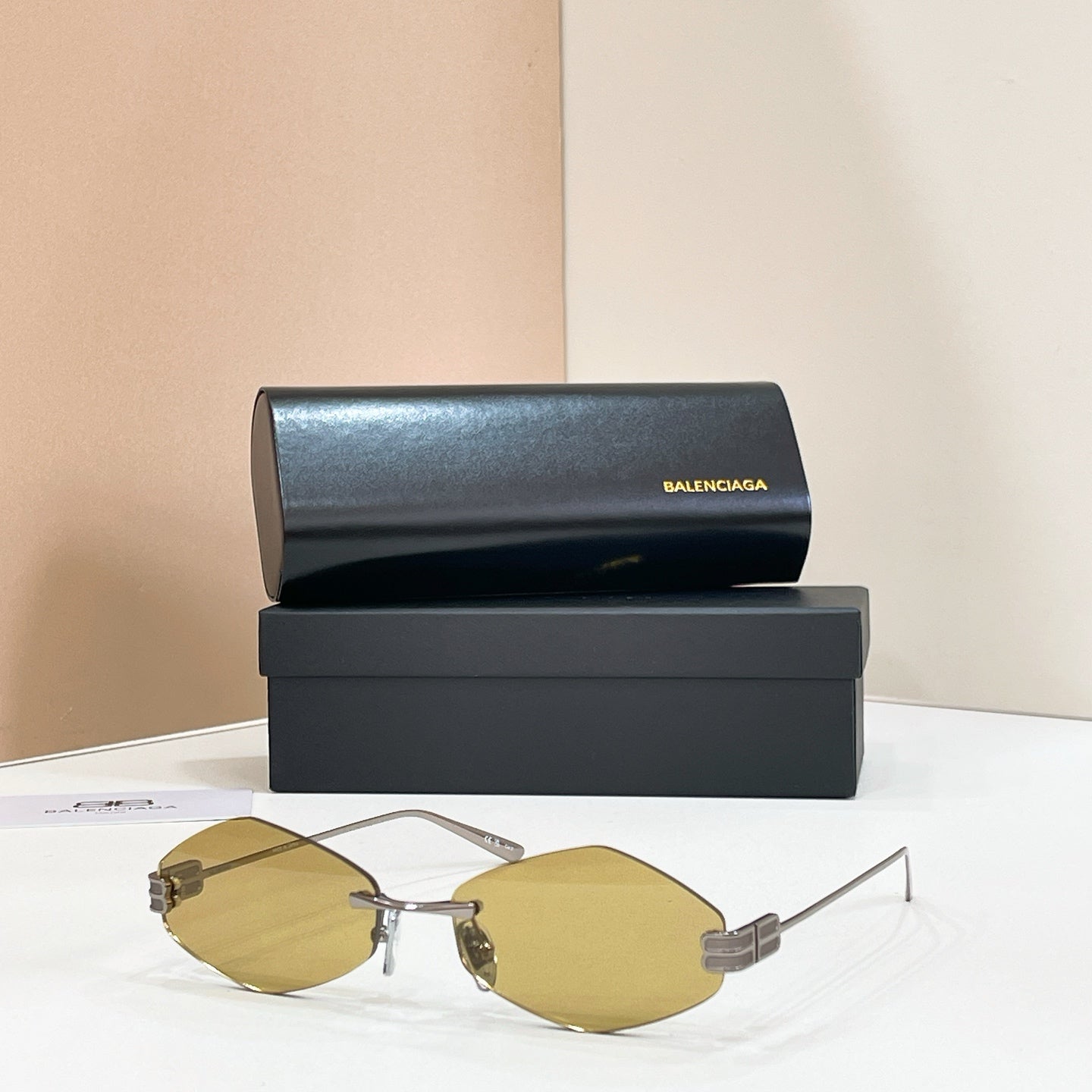 Sunglasses with gold-tone metal frame and light yellow-tinted lenses