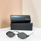 Sunglasses with gold-tone metal frame and dark lenses