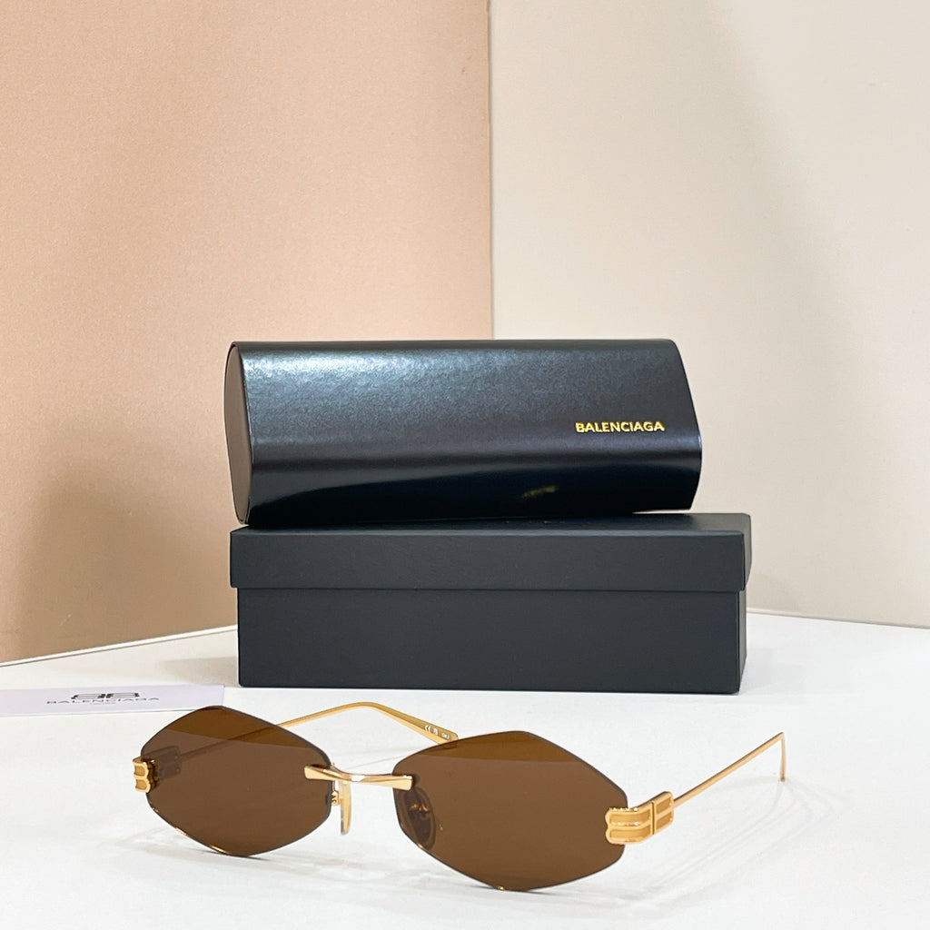 Sunglasses with gold-tone metal frame and dark brown lenses