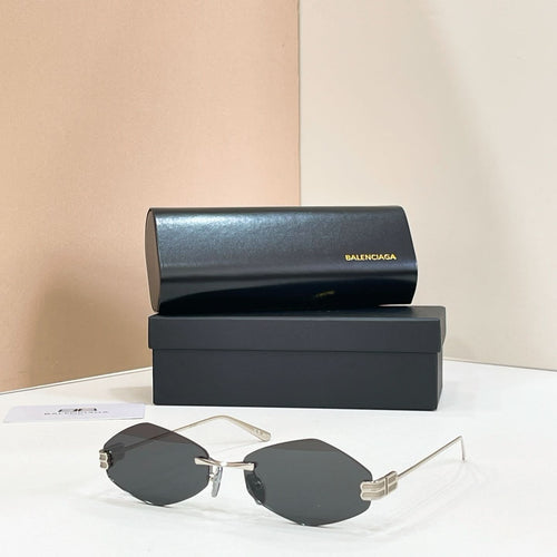 Balenciaga round sunglasses with gold-tone metal frame and dark smoke lenses