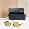 Gold round sunglasses with amber lenses and thin metal bridge detail