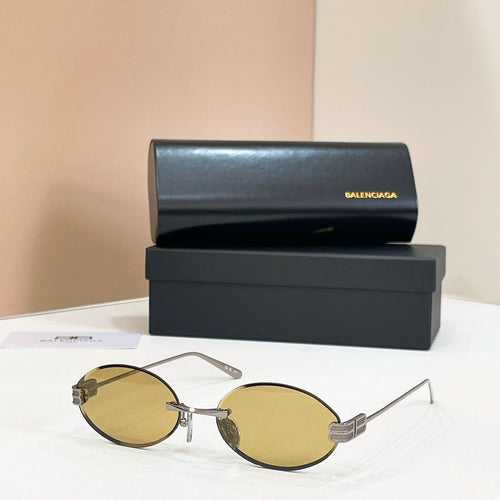 Gold round sunglasses with amber lenses and thin metal bridge detail
