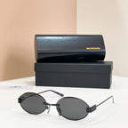 Round sunglasses with dark lenses and clear temples