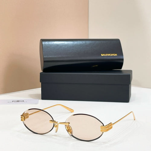Gold round sunglasses with light pink lenses and thin metal bridge detail