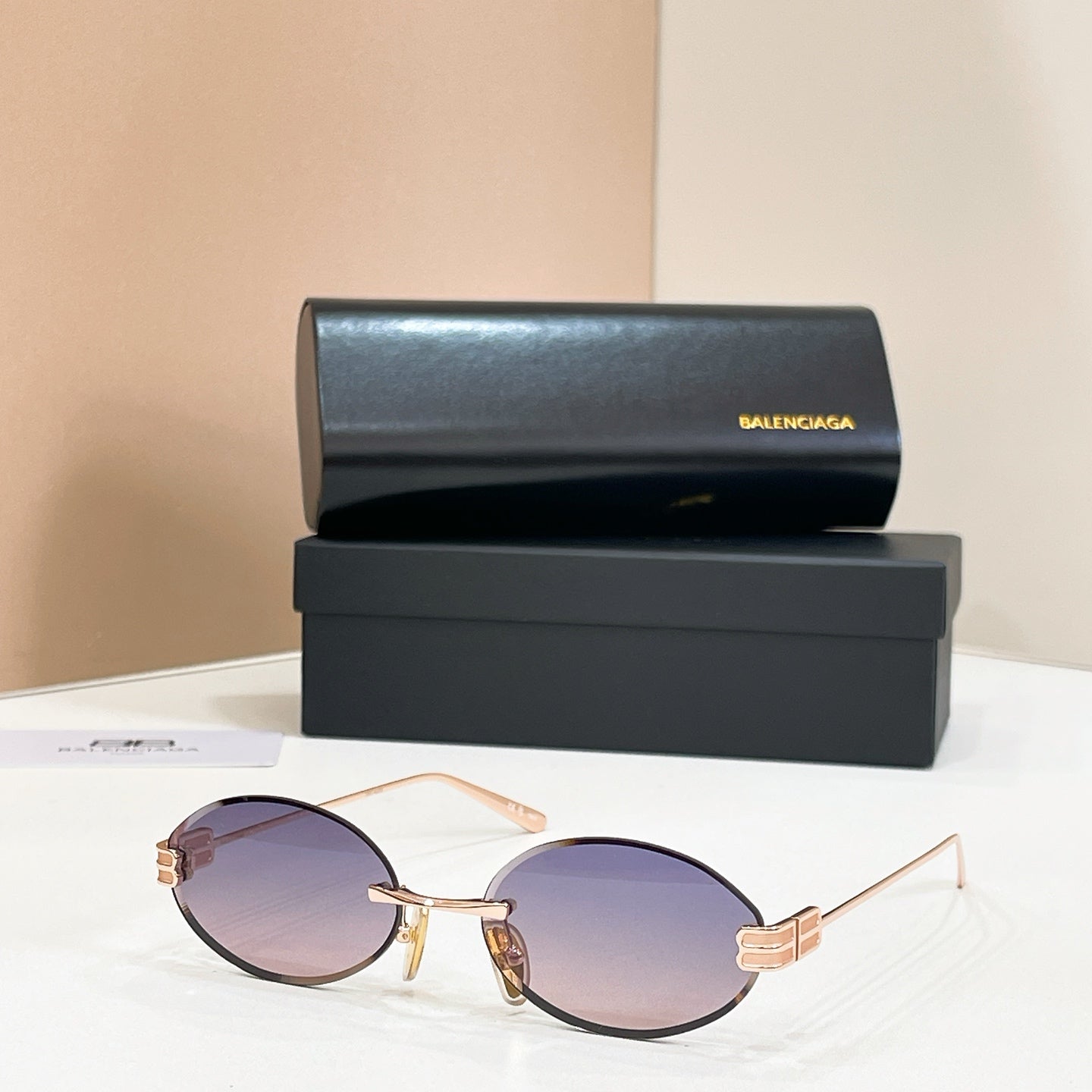 Gold round sunglasses with purple lenses and thin metal bridge detail