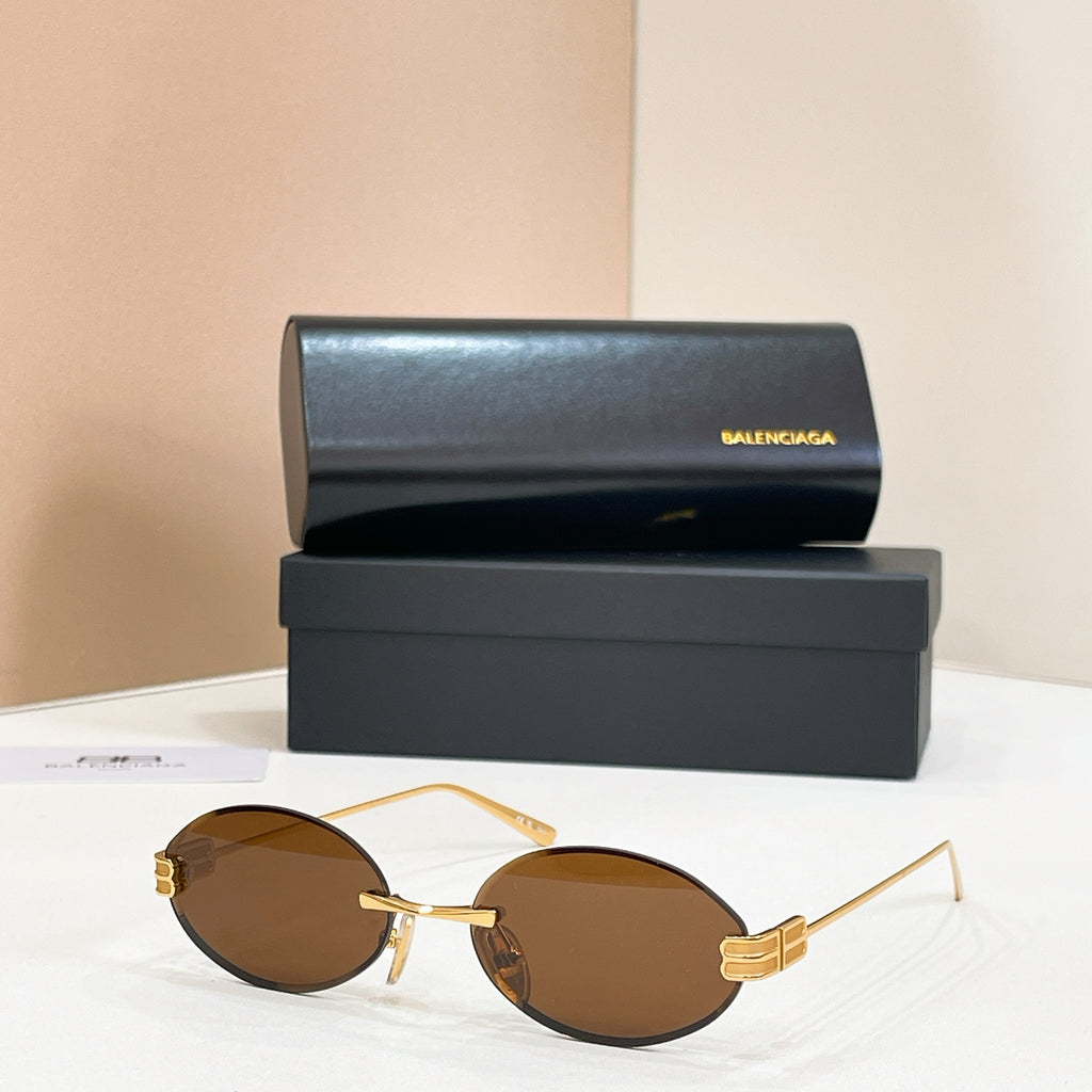 Gold round sunglasses with brown lenses and thin metal bridge detail