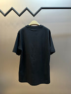 Black short-sleeve T-shirt back view on a hanger, plain design.