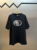 Black short-sleeve T-shirt with oval Burberry logo patch on the chest.