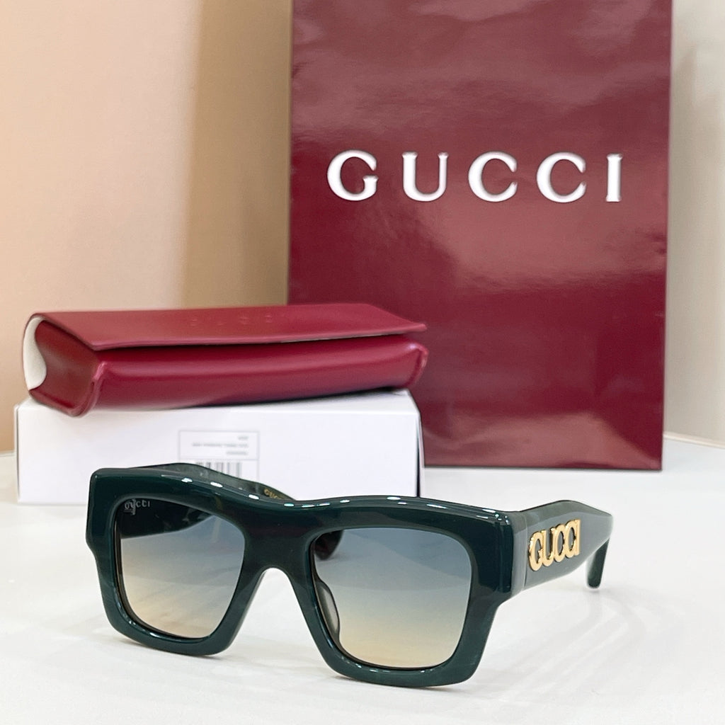 Gucci glasses with dark green square frames and tinted lenses, gold logo on temple.