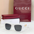 Gucci glasses with white square frames and dark lenses, gold logo on temple.
