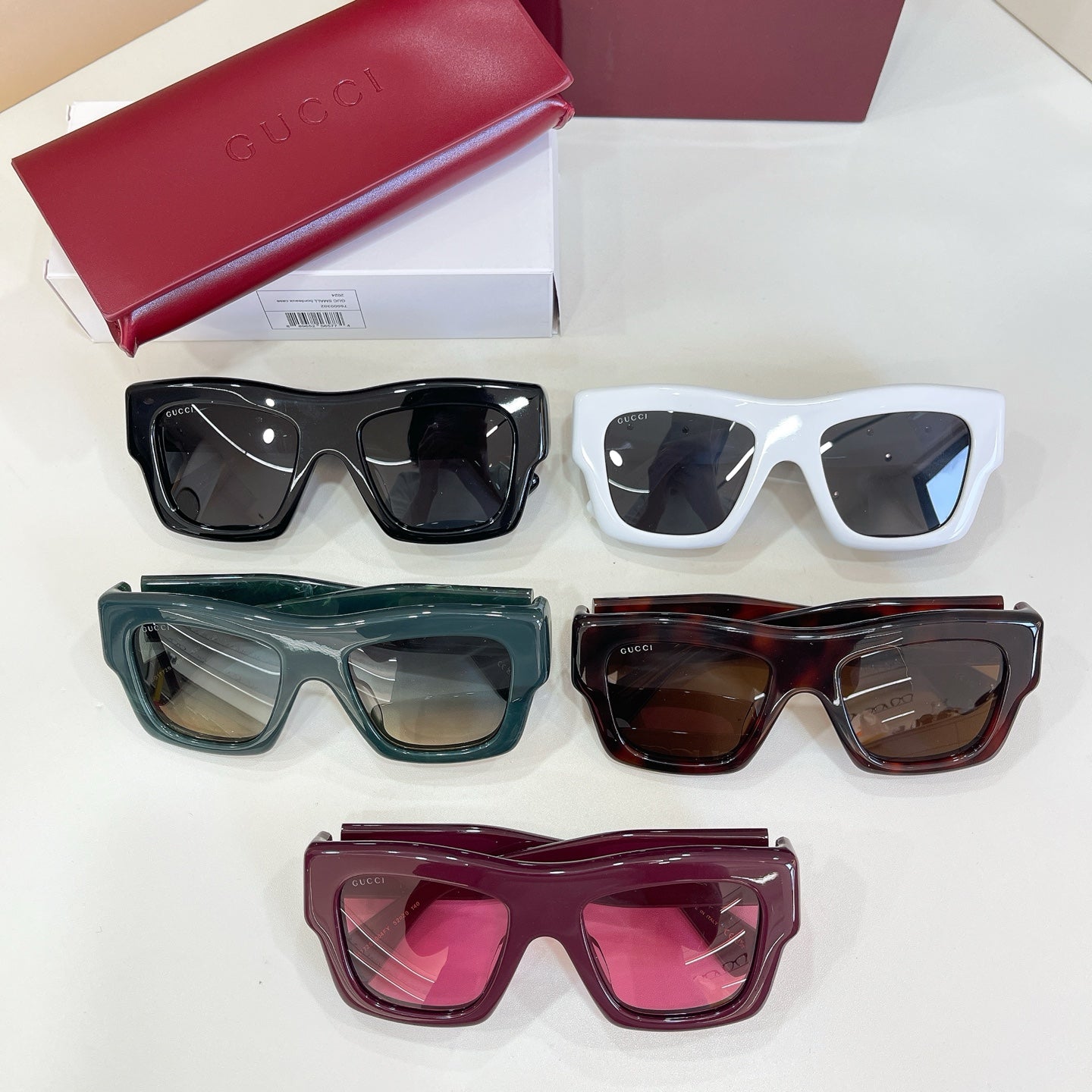 Gucci glasses set of five pairs: white, black, green, tortoiseshell, and burgundy frames.