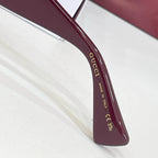 Gucci glasses temple detail with 'Made in Italy' text in gold lettering.