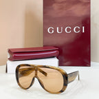 Gucci oversized tortoiseshell sunglasses with golden lenses and dark temples