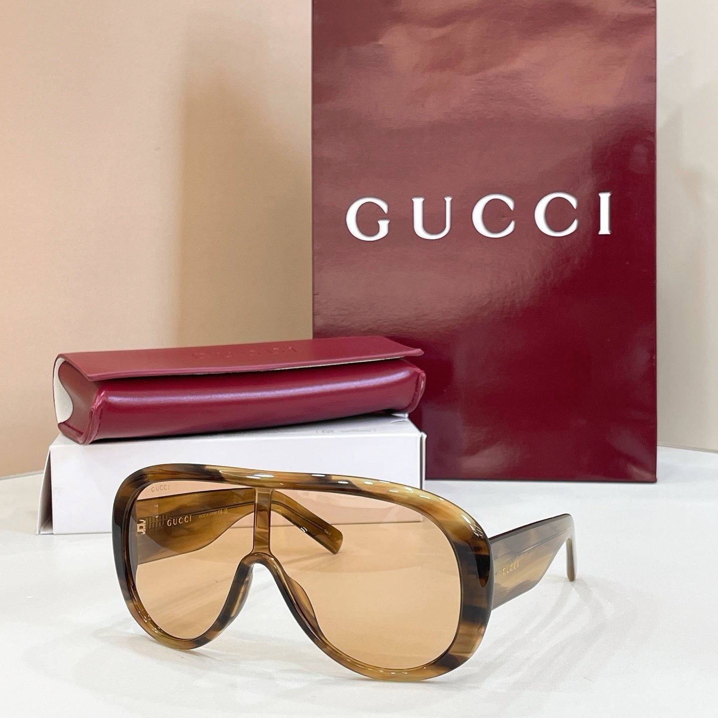 Gucci oversized tortoiseshell sunglasses with golden lenses and dark temples