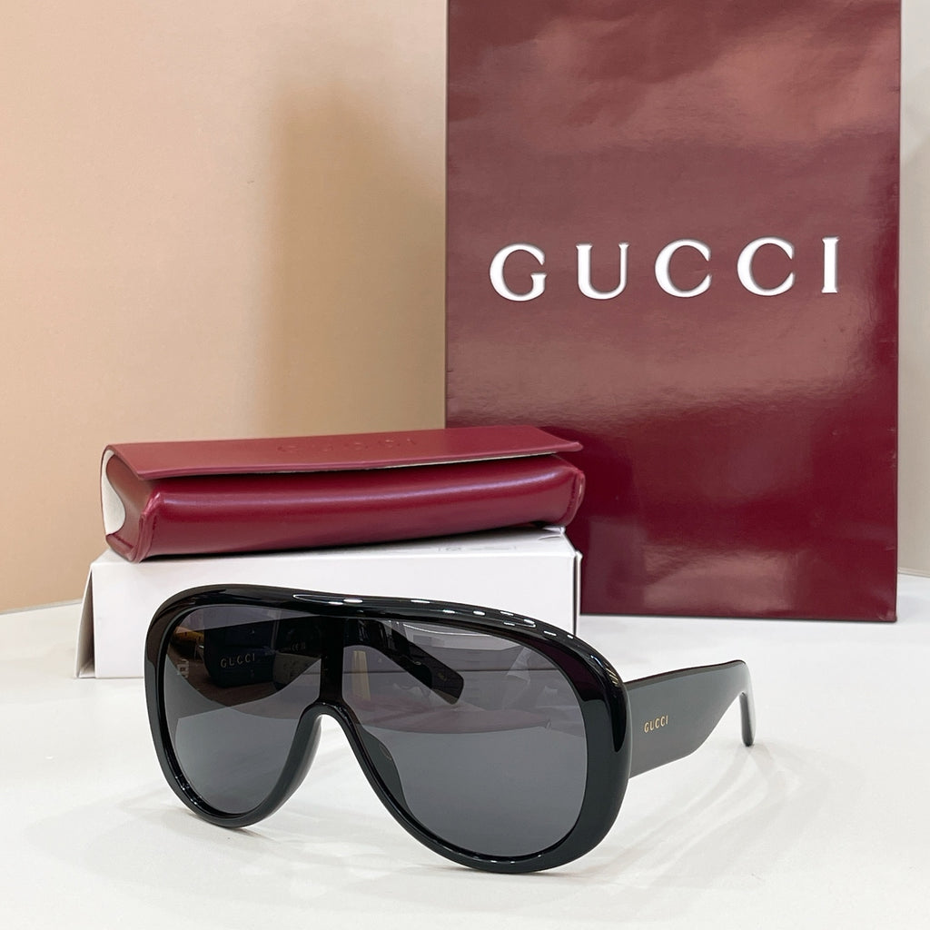 Gucci oversized black sunglasses with dark gray lenses and angled temples