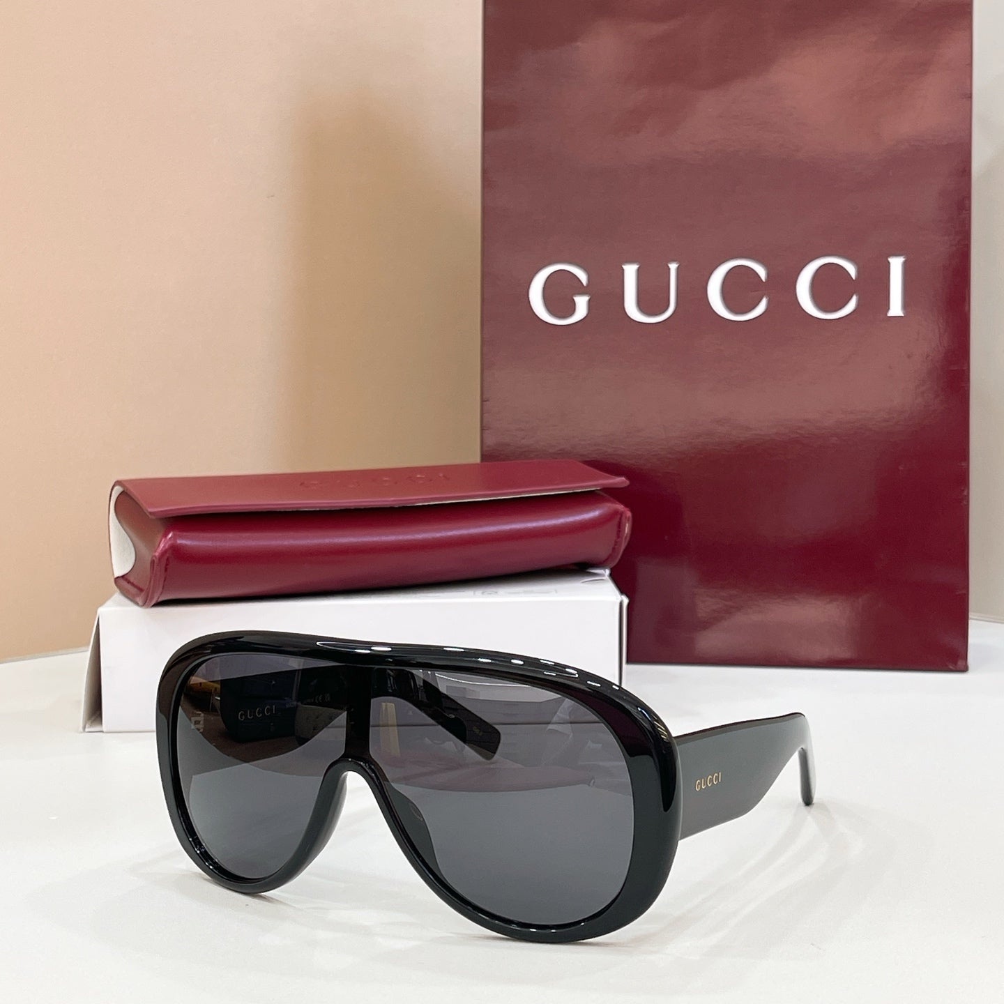 Gucci oversized black sunglasses with dark gray lenses and angled temples